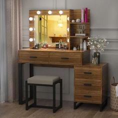 a dressing table with lights on it and a stool