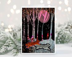 a greeting card featuring two foxes in the woods with snow falling on them and christmas lights