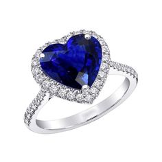 a heart shaped blue sapphire and diamond ring with diamonds around the band, set in 18k white gold