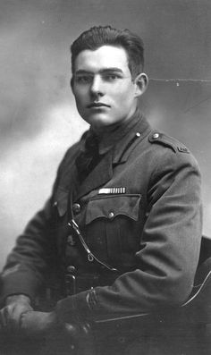 an old black and white photo of a man in uniform