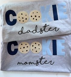 two t - shirts with cookie cookies on them, one is grey and the other is blue