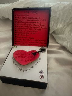 a heart shaped brooch in a box on a bed with the words song of love