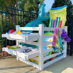 an outdoor play area with plastic toys and water slides on it's back deck