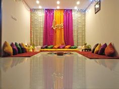 a living room filled with lots of colorful pillows