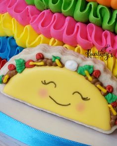 there is a taco cake on top of the cake and it's icing