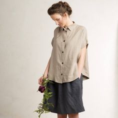 Beautiful loose fit linen womens shirt with short sleeves. Carefully handmade of very soft medium weight pure linen fabric. Designed and sewed by LHI team in very small quantities - so you know youre getting an unique item! Composition: 100% linen Closure: black buttons Color: flax Summer Flax Shirt With Buttons, Summer Tops In Flax Color With Buttons, Summer Workwear Shirt In Flax Color, Flax Shirt For Summer Workwear, Flax Summer Shirt For Workwear, Summer Flax Shirt For Work, Summer Linen Short Sleeve Shirt With Buttons, Short Sleeve Linen Shirt With Buttons For Summer, Summer Linen Short Sleeve Blouse