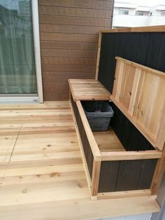 a wooden bench sitting on top of a hard wood floor next to a window and door