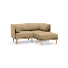 a beige sectional couch with wooden legs on an isolated white background, facing the right