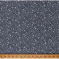 a blue and white fabric with small stars on it, as well as a ruler