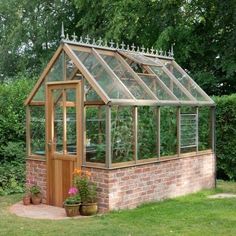 a small brick building with a glass roof