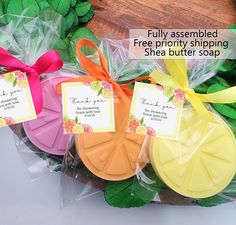 three soaps in plastic bags with ribbons tied around them