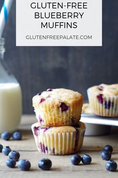 two blueberry muffins sitting next to a bottle of milk