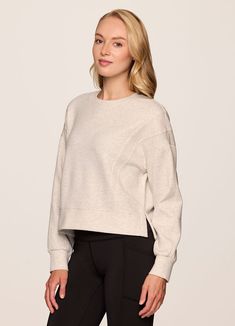 Our In The Studio Cropped Pullover combines a classic crewneck design and super soft, trendy scuba fabric for a lightweight pullover you can take from studio to street. A slightly cropped length is complemented by a relaxed fit, dropped shoulders and sporty seaming detail that allow for easy styling and layering. Throw this cute crop sweatshirt over a sports bra for a workout or pair it with jeans for a casual-cute look. Versatile Crew Neck Tops With Ribbed Cuffs, Relaxed Fit Cropped Sweater For Layering, Crew Neck Relaxed Fit Cropped Sweater In Athleisure Style, Athleisure Relaxed Fit Crew Neck Cropped Sweater, Oversized Sporty Cropped Sweater With Crew Neck, Sporty Oversized Cropped Sweater With Crew Neck, Versatile Crew Neck Sweatshirt For Layering, Stretch Crew Neck Sweatshirt With Ribbed Waistband, Stretch Sweatshirt With Ribbed Waistband And Crew Neck