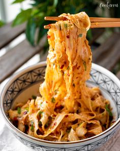 a bowl filled with noodles and chopsticks on top of it