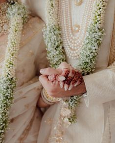 the bride and groom are holding hands together