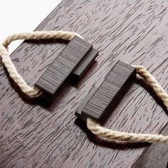 two pieces of wood with rope attached to them