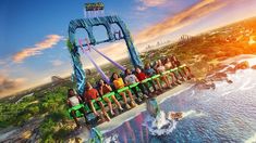 a roller coaster ride with people sitting on it in front of the sun and water