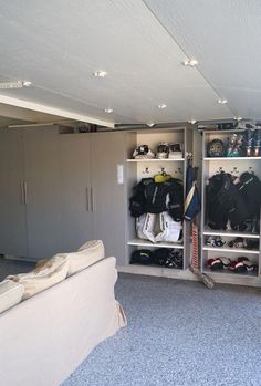 a living room filled with furniture and lots of clutter on top of the shelves