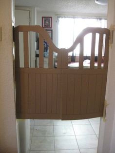 an open door leading into a kitchen with tile flooring