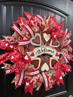 a red and white welcome wreath with hearts