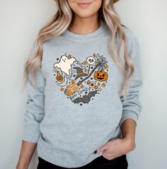 Cute Love Halloween Sweatshirt, Pumpkin Ghost Sweater, Jack-o-Lantern Sweatshirt, Halloween Crewneck, Spooky Season Gift, Fall Shirts Want the 'Love Halloween' T-Shirt instead?  Click here:  https://www.etsy.com/listing/1530224410/ ---HOW TO ORDER--- 1 ) Please, check and review all photos for important ordering information 2 ) Choose your size based on the measurements in the size chart photos   3)  Select your color. 4)  Select the quantity. 5)  Click add to cart. You can go back to add additi Fall Crew Neck Top With Heart Graphic, Spooky Fall Crew Neck Tops, Spooky Crew Neck Tops For Fall, Fall Long Sleeve Heart Graphic T-shirt, Long Sleeve Heart Graphic T-shirt For Fall, Fall Long Sleeve T-shirt With Heart Graphic, Long Sleeve T-shirt With Heart Graphic For Fall, Fall Long Sleeve Top With Heart Graphic, Ghost Sweater