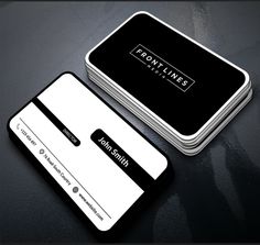 two business cards sitting next to each other on top of a black table with white trim