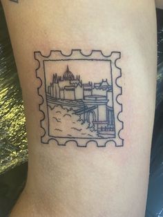 a stamp with an image of a city on it's side, in the shape of a stamp