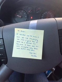 a note attached to the steering wheel of a car