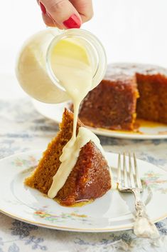 someone pouring icing onto a piece of cake on a plate