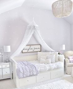 a white bed sitting in a bedroom on top of a floor next to a dresser