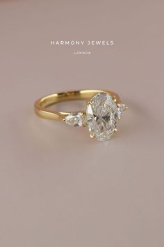 a yellow gold engagement ring with an oval cut diamond