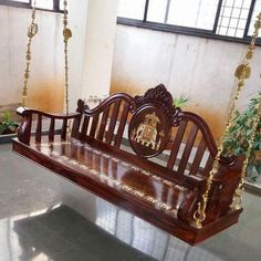 a wooden bench with chains hanging from it's sides