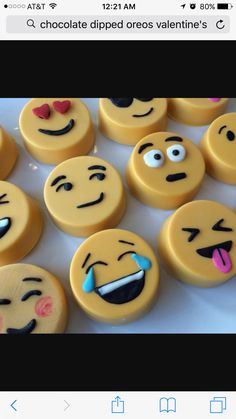 there are many cookies with different faces on them, all decorated in yellow icing