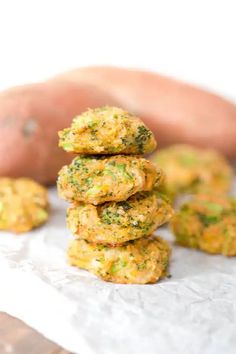 broccoli patties stacked on top of each other in front of a potato