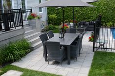 an outdoor dining set with umbrella and chairs