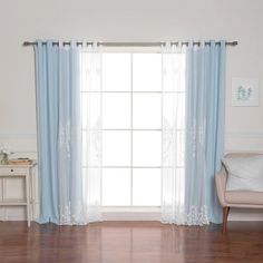 a living room with white walls and blue curtains