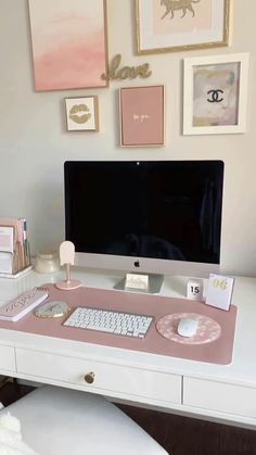 a white desk topped with a computer monitor and keyboard