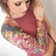 a woman with tattoos on her arms and shoulder