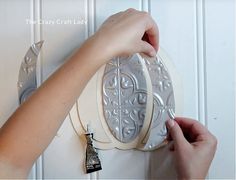 a person holding onto a door knob on a white wall