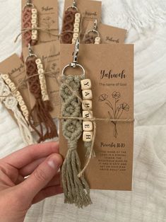 handmade keychains with words and tassels attached to them, tied in twine