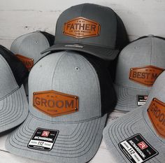 five hats with leather patches on them sitting next to each other