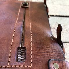 a brown piece of luggage sitting on top of a floor