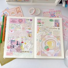 an open book with stickers on it next to markers, pens and other crafting supplies