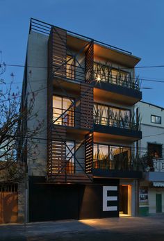 an apartment building with balconies lit up at night