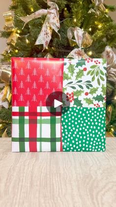 two wrapped presents sitting in front of a christmas tree