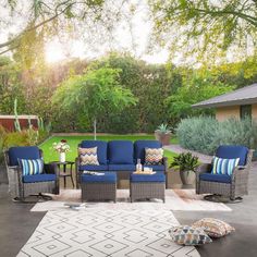 an outdoor living room with blue and white furniture