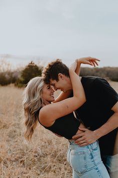 a man and woman embracing in a field