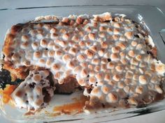 a dessert with marshmallows on top in a glass baking dish, ready to be eaten