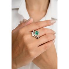 This amazing engagement ring features a creative design, highlighting a stunning emerald at its center, surrounded by sparkling diamonds. Set in luxurious 18K white gold, the intricate detailing enhances the ring's elegance. The vibrant green emerald and radiant diamonds create a unique and timeless piece, perfect for a memorable proposal. Emerald enhances intellectual capacity of the person.  Designed with square cut emerald set with halo diamonds set on a diamond chevron ring that makes it a perfect fit to wear it on your wedding or style it with any of your basic outfit to give it a glam. This is a perfect Emerald Ring. This is a perfect May Birthstone Jewelry also perfect Grandma Gift, Valentine Gift, Gift For Mom, Wedding Gift, Engagement Gift, Mother Daughter Gift, Bride To Be Gift, Luxury Diamond White Emerald-cut Ring, Luxury Diamond Ring With May Birthstone Accents, Luxury Asscher Cut Diamond Emerald Ring, Luxury May Birthstone Diamond Ring With Accents, Elegant Princess Cut Emerald Ring In Platinum, Luxury White Gold Asscher Cut Emerald Ring, White Gold Emerald Ring Luxury, Luxury Diamond Ring For May Birthstone, Elegant Emerald Asscher Cut Wedding Ring