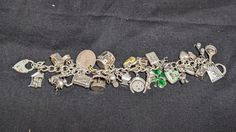 Incredible vintage / antique charm bracelet. 26 unique charms: 1.Frying pan with an egg. Stamped "Sterling". 2.February Pisces charm with two fish and "February". Stamped "Sterling". 3.A skateboard with moving wheels. Stamped "Sterling". 4.Double, baby shoes, charm. Jeweler verified as Sterling Silver.  5.A mailbox charm, with a heart on the front and moveable flag. Stamped "Sterling". 6.Double hart charms. Stamped "Mexico". Jeweler verified as Sterling Silver.  7.A comedic pig cartoon figure, holding u one finger and holding a shovel or cement spatula. It is stamped with a copyright symbol. Jeweler verified as Sterling Silver.  8.LaMode Guilloche Enamel Rose Heart Charm with a mint green background. Stamped "Sterling" and "LAMODE".  9.A four-leave clover with dark green enamel work. Stamp Luxury Metal Charm Bracelet With Vintage Charm, Victorian Sterling Silver Charm Jewelry, Heirloom Charms Jewelry For Collectors, Antique Charm Bracelet With Vintage Charm, Antique Jewelry With Dangling Charms For Collectors, Vintage Sterling Silver Charm Bracelet For Jewelry Making, Antique Charm Bracelet For Jewelry Making, Collectible Sterling Silver Jewelry With Vintage Charm, Collectible Vintage Charm Costume Bracelet